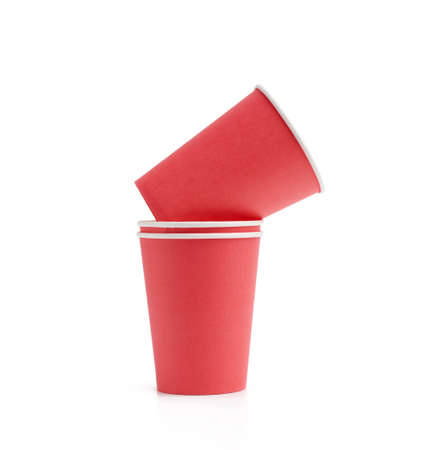 stack of red paper cups for hot takeaway drinks isolated on a white background. Plastic rejection concept, zero wasteの写真素材