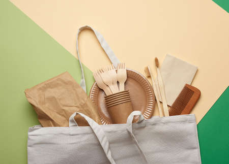 disposable paper utensils from brown craft paper and recycled materials on a green background, plastic rejection concept, zero wasteの写真素材