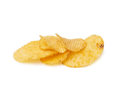 heap of corrugated round yellow fried potato chips isolated on white background, food with spice