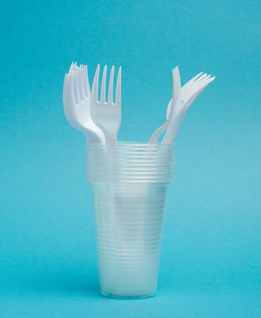 disposable plastic cups, forks on a blue background, picnic set