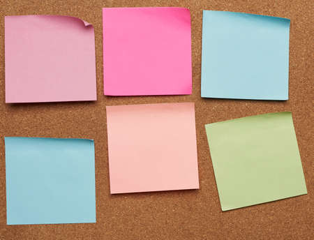 colorful paper stickers glued on brown balsa board, idea and multitasking, close up
