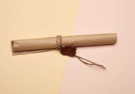 brown paper roll sealed with wax seal, top view, close upの写真素材