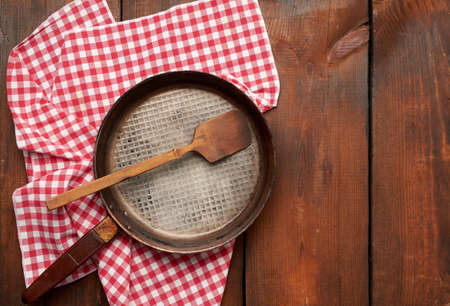empty round frying pan with handle on brown wooden table, top viewの写真素材