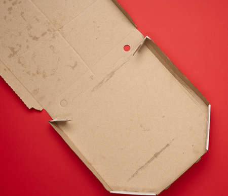open empty square cardboard white pizza box on red background, top viewの写真素材