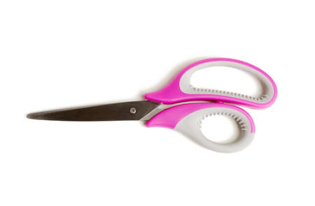 metal scissors with pink plastic handle isolated on white background, close up