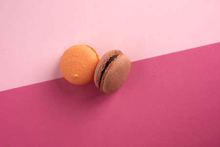baked multi-colored macaroon cookies on a red background, top view, copy spaceの写真素材