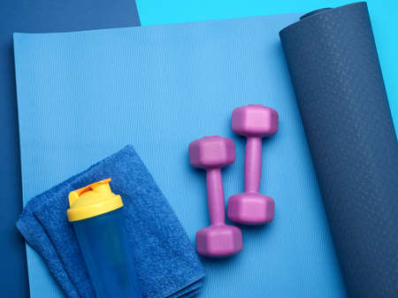 pair of dumbbells, sports gloves and blue sports mat, top viewの写真素材