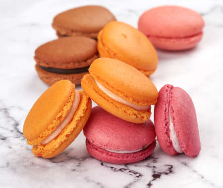 stack of baked macarons on a white table, close up