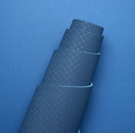 neoprene blue twisted mat lies on a blue background, sports equipment, top view