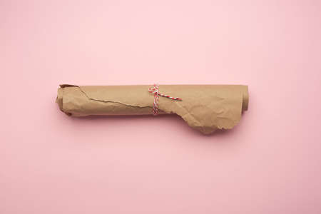 roll of brown paper on pink background, top viewの写真素材