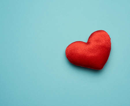red velor heart on blue background, top view, copy spaceの写真素材