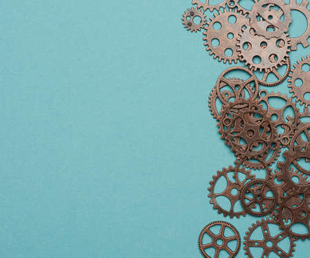 copper various cogs on a blue background, copy space