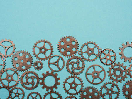 copper various cogs on a blue background, copy space