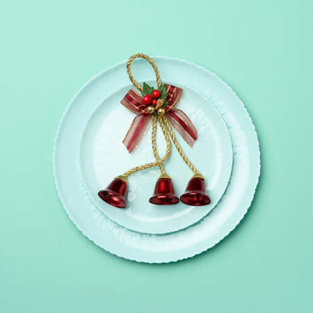 green round red ceramic plate, festive table setting for christmas and new year, top viewの写真素材
