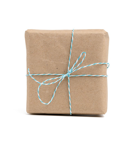 square box wrapped in brown kraft paper and tied with rope, gift isolated on white background