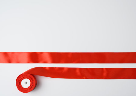 red summer silk and bobbin on white background, festive decorの写真素材