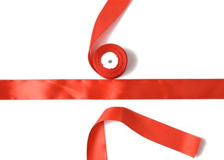 red silk ribbon in a reel on a white background, gift wrapping, templateの写真素材