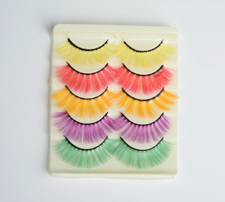 multi-colored false eyelashes in plastic packaging on a white background, close upの写真素材