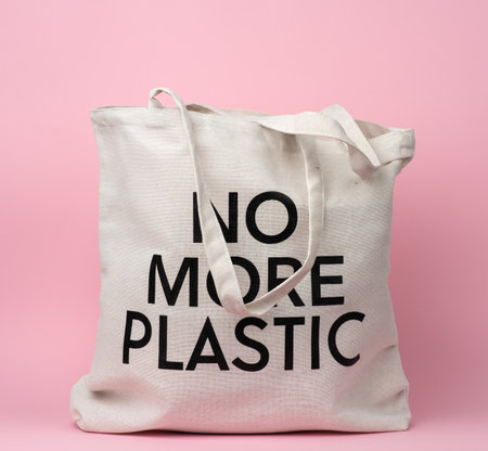 beige textile bag with an inscription no more plastic on a pink background, no plasticの写真素材