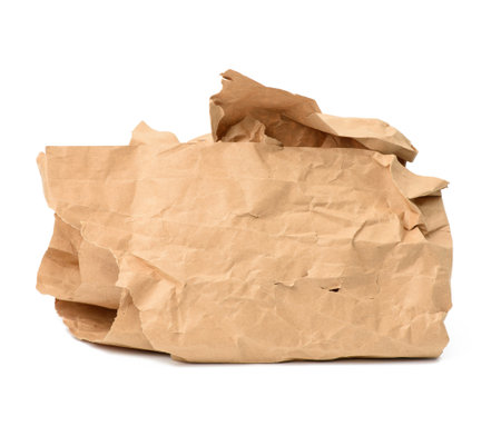 piece of crumpled brown paper isolated on white background, element for designer, close upの写真素材