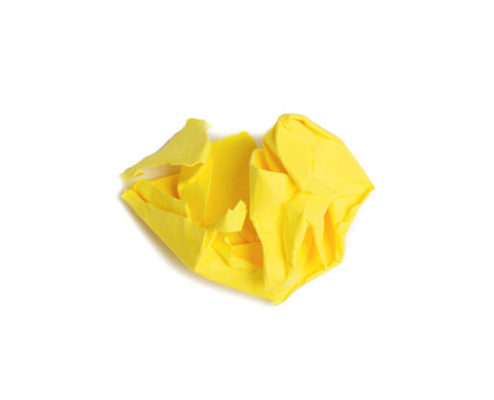 crumpled ball of brown sheet of yellow paper isolated on white background, element for designerの写真素材