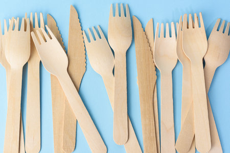 wooden forks and knives on a blue background, zero wasteの写真素材