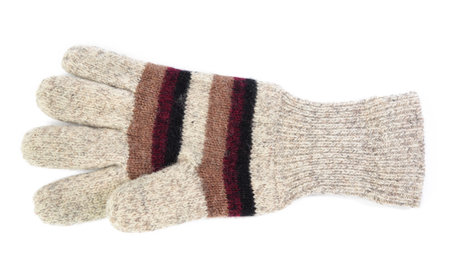 knitted woolen mitten from gray threads, isolated on white background, close up