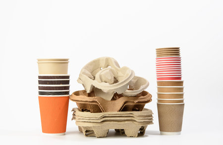 stack of paper takeaway beverage holders and disposable cups on a white background, zero wasteの写真素材