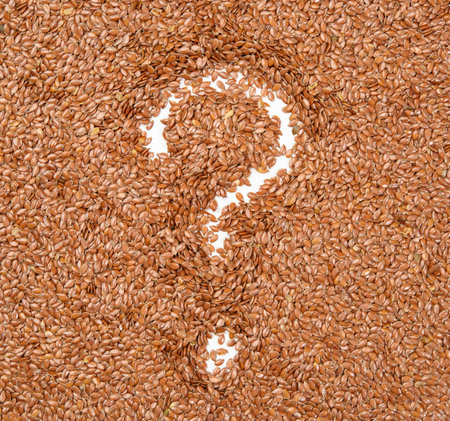 painted question mark on scattered flax seeds, close upの写真素材