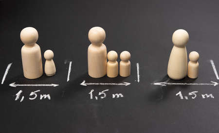 social distancing concept during pandemic and epidemics, contact avoidance, wooden figurines and...