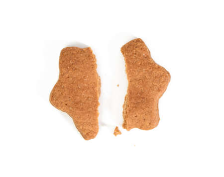Star shaped baked chocolate gingerbread cookie cut in half and isolated on white background