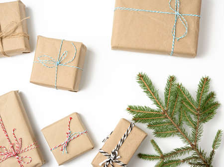 box wrapped in brown kraft paper and tied with rope, gift on white background, top view