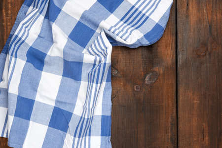 textile kitchen blue towel on a wooden surface made of brown planks, copy spaceの写真素材