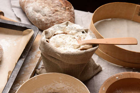 white wheat flour in a small burlap sack, close up