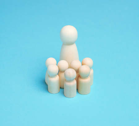 wooden figurines of mom and children on a blue background, large family