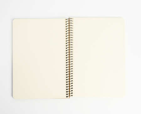 open spiral notepad with blank white sheets on white background, close up