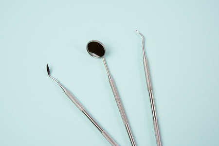 metal medical items of the dentist on a blue background, flat layの写真素材