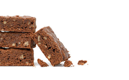 stack of baked chocolate brownie pieces with walnut isolated on white background, delicious dessert, copy spaceの写真素材