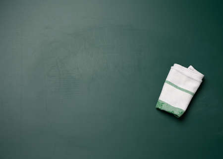 white textile rag on empty chalk school blackboard, copy spaceの写真素材