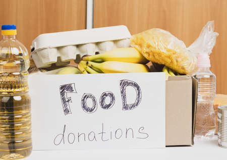 cardboard box with various products, fruits, pasta, sunflower oil in a plastic bottle and preservation. Donation conceptの写真素材
