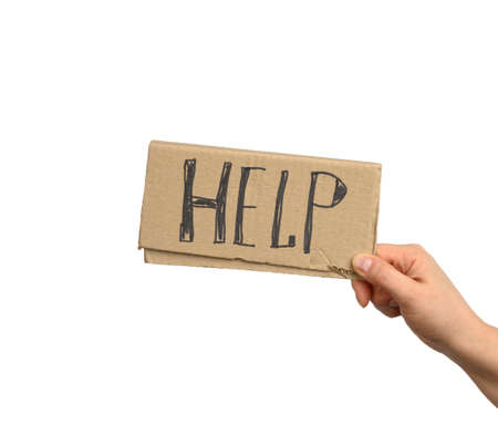 hand holds a piece of cardboard with the inscription help, mutual assistance concept, homeless,...