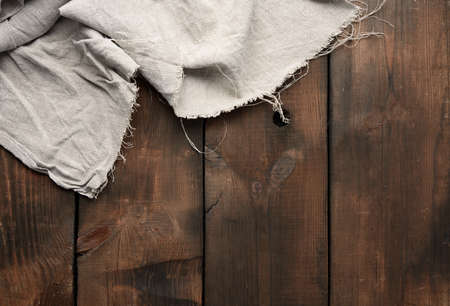 gray kitchen towel on brown wooden background, top view, copy spaceの写真素材