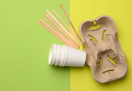 white paper disposable cups and brown tray, green background, takeaway containersの写真素材