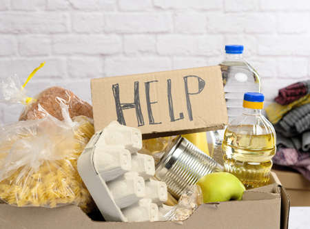 cardboard box with various products, fruits, pasta, sunflower oil in a plastic bottle and preservation. Donation conceptの写真素材