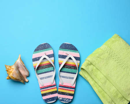 rubber womens striped slippers on a blue background, top view, place for an inscriptionの写真素材