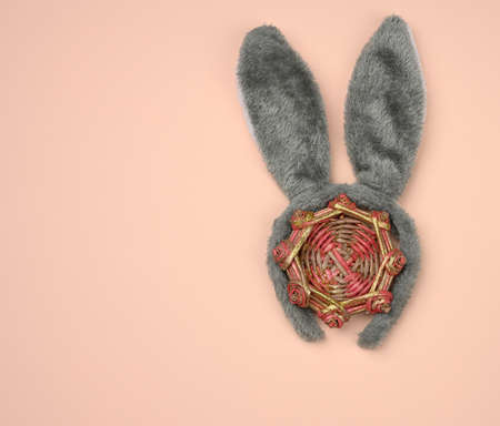 rabbit mask on the head with ears on a beige background, festive backdrop, top view