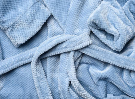 a fragment of a gray-blue plush robe with a belt, close upの写真素材