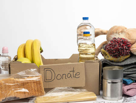 cardboard box with various products, fruits, pasta, sunflower oil in a plastic bottle and preservation. Donation conceptの写真素材
