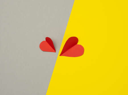 two paper hearts on a yellow-gray background, top viewの写真素材