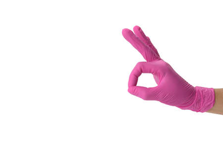 hand in pink medical glove shows ok gesture, white background, approval concept, copy spaceの写真素材